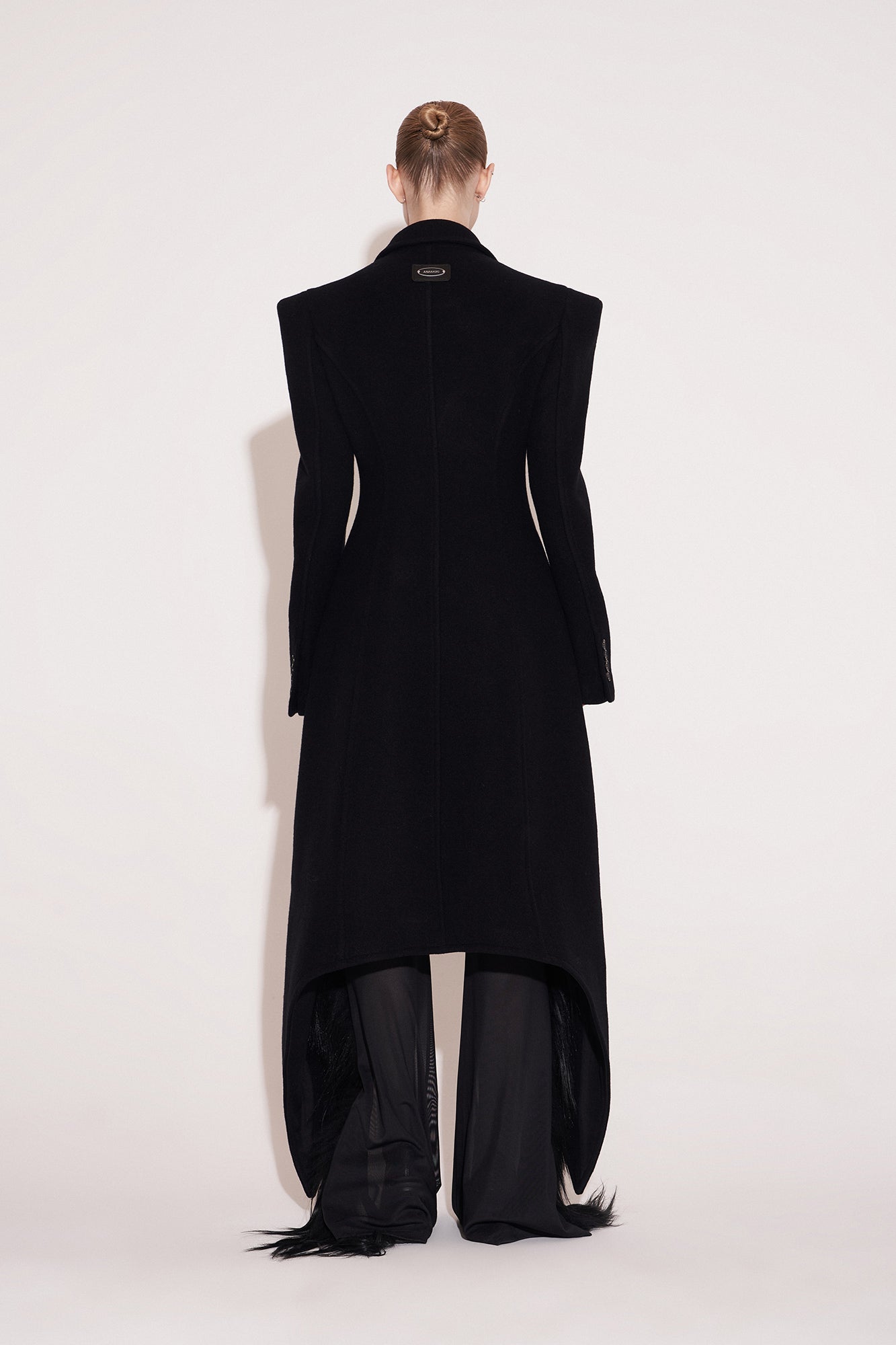 Wool coat with wide shoulders and swallowtail hem