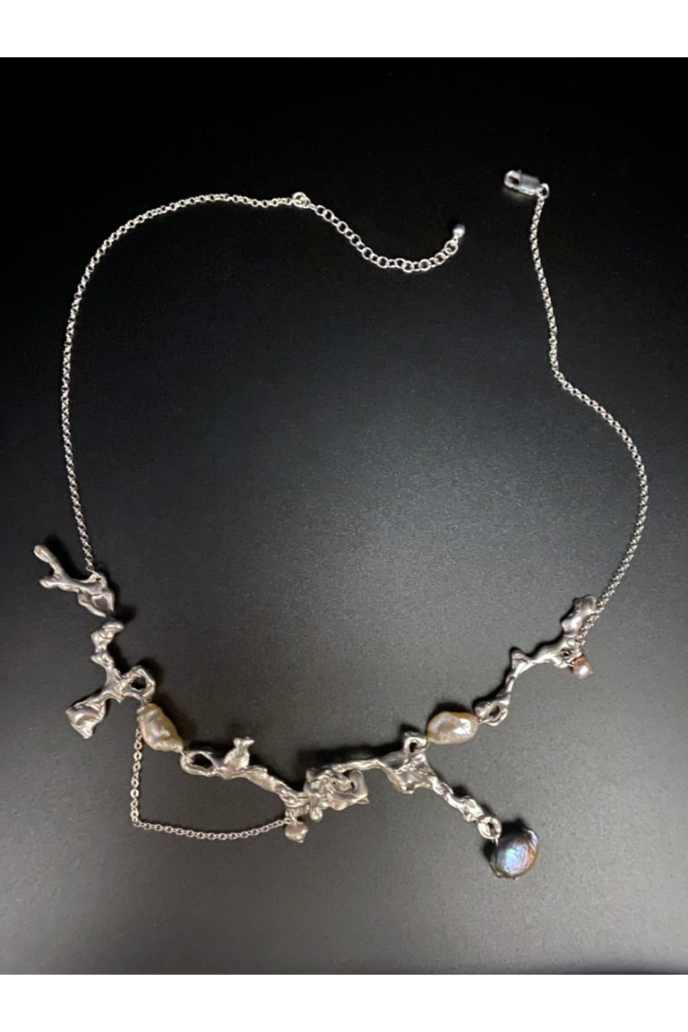 Fluid erosion necklace