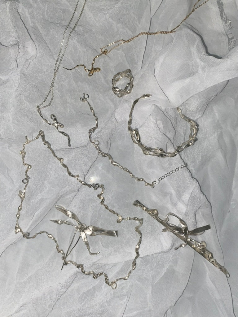 Burnt bow pendant - silver