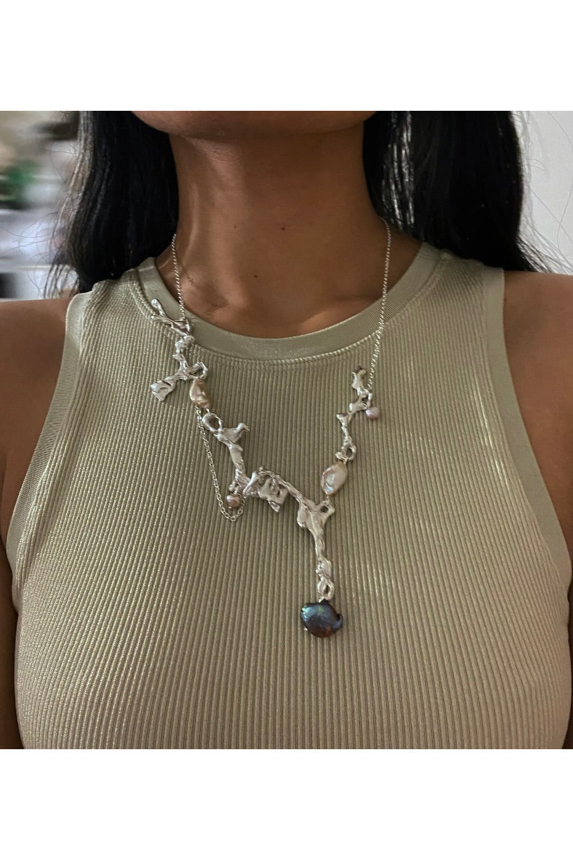 Fluid erosion necklace