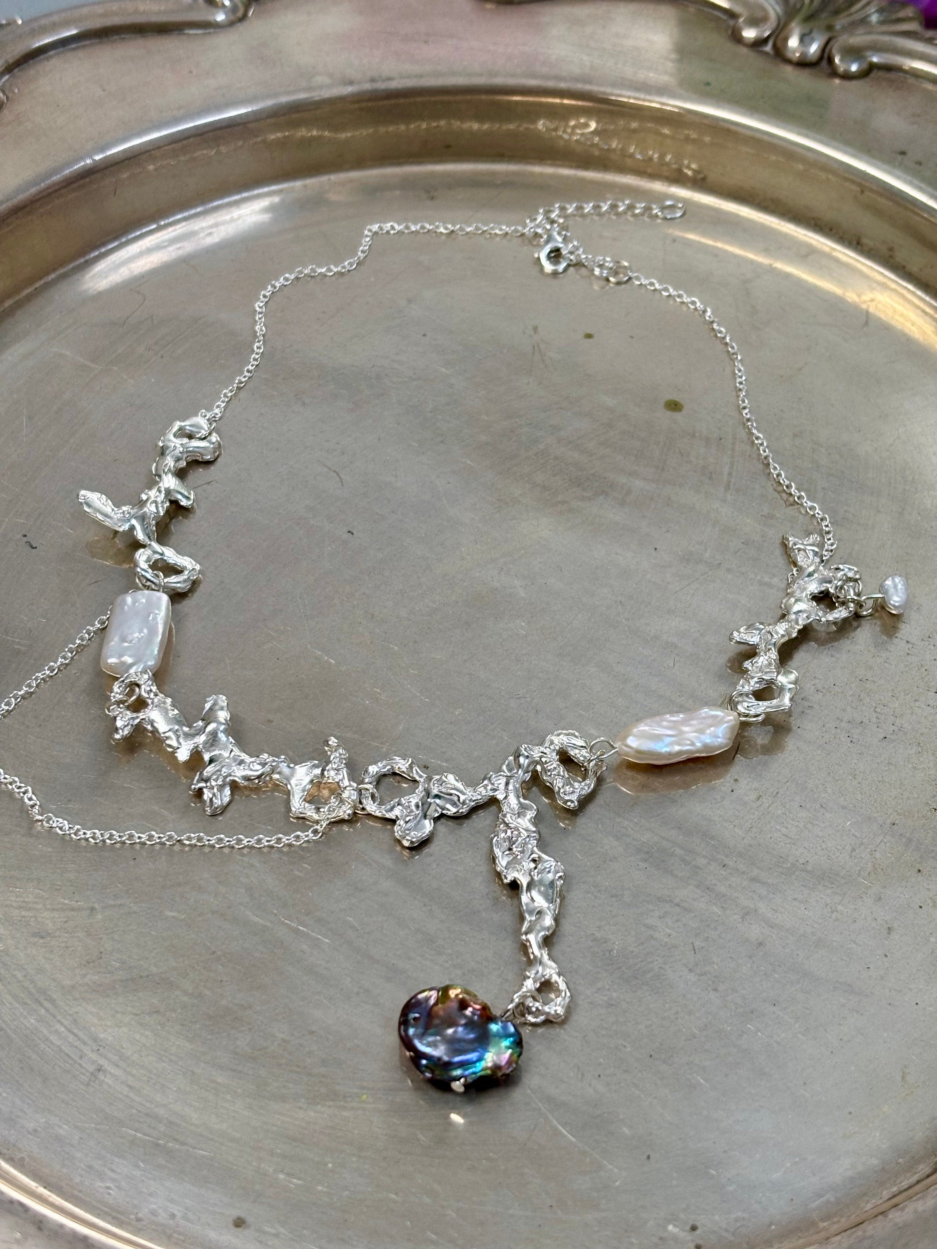 Fluid erosion necklace
