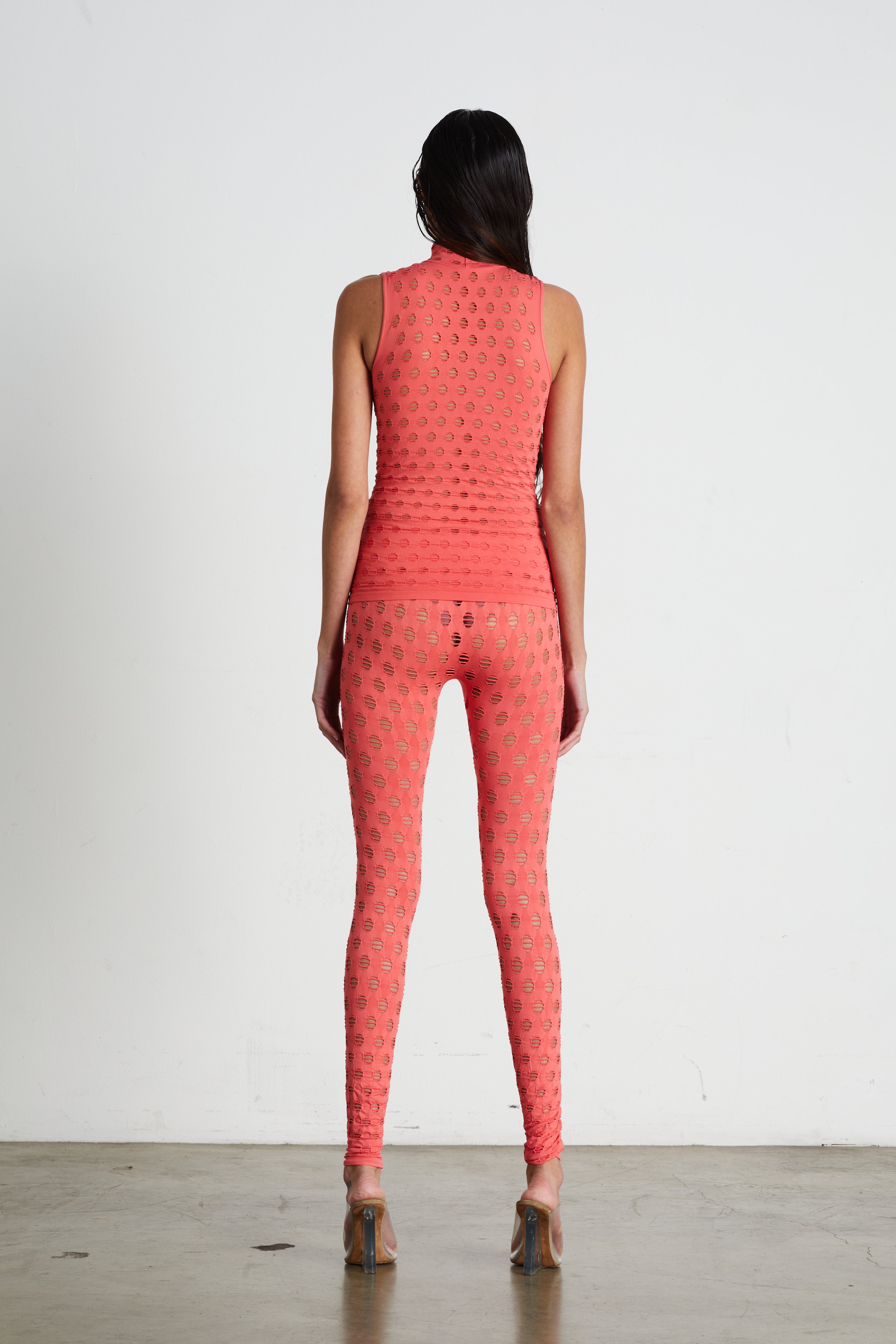 Perforated sleeveless turtleneck