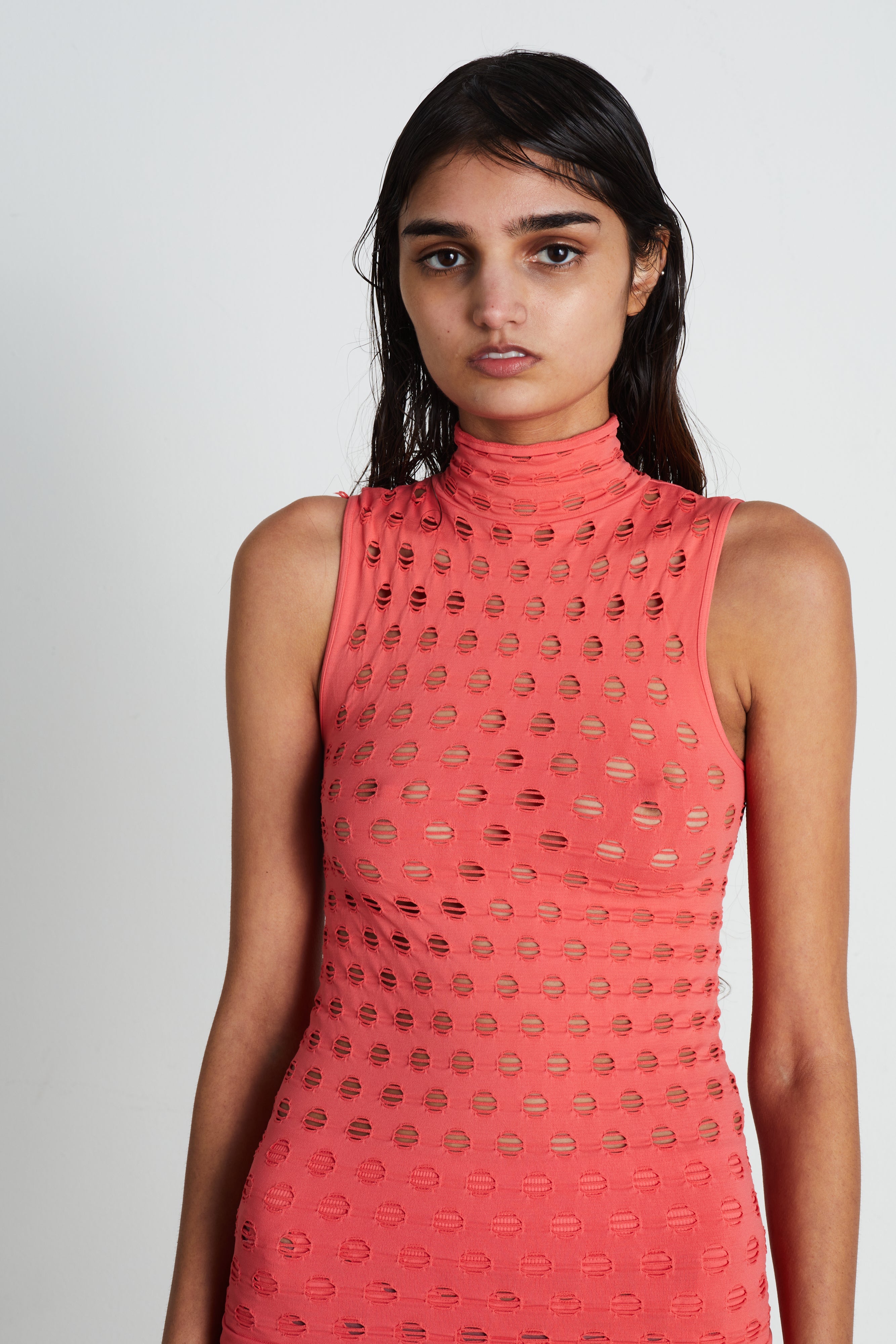 Perforated sleeveless turtleneck