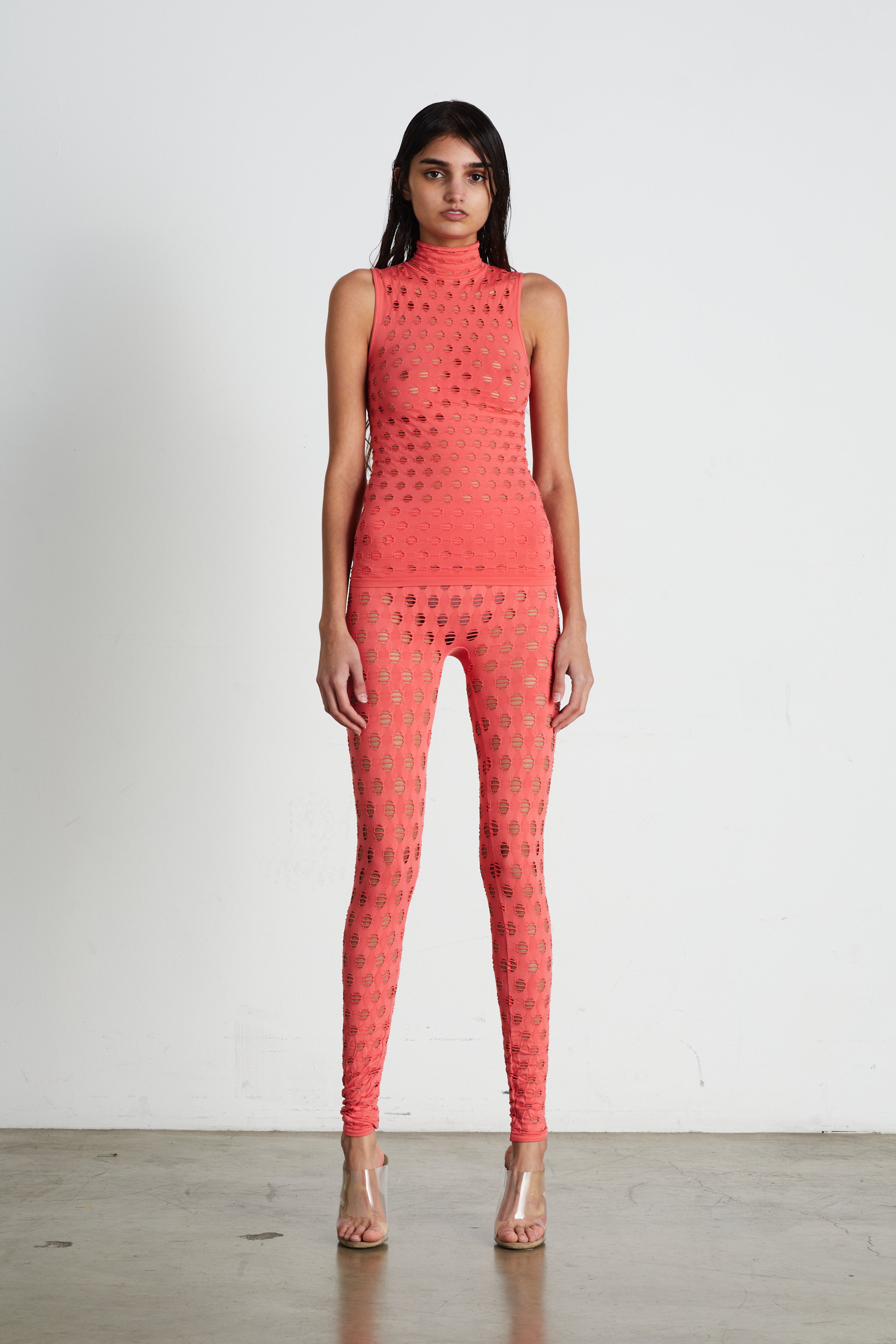 Perforated sleeveless turtleneck