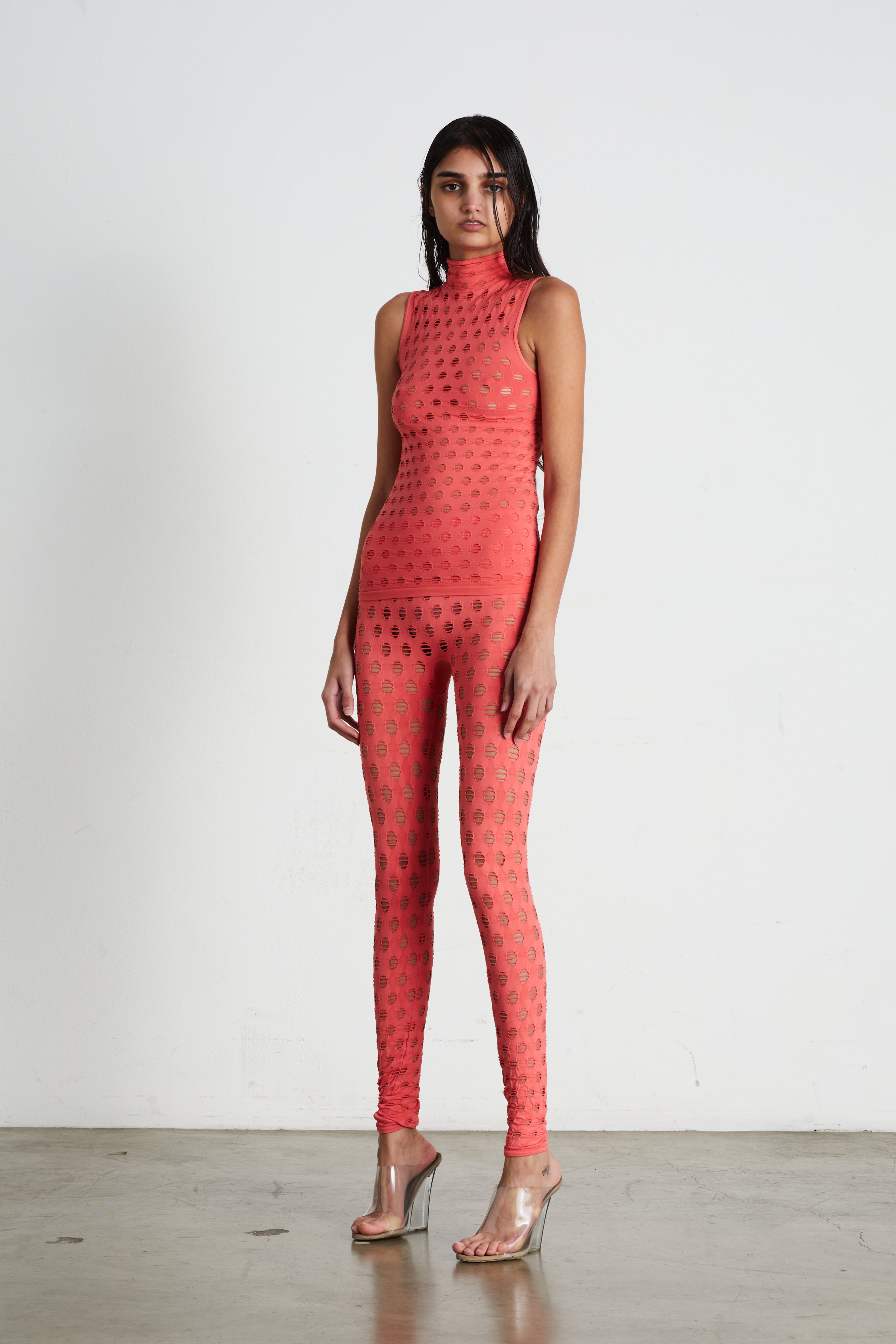 Perforated sleeveless turtleneck