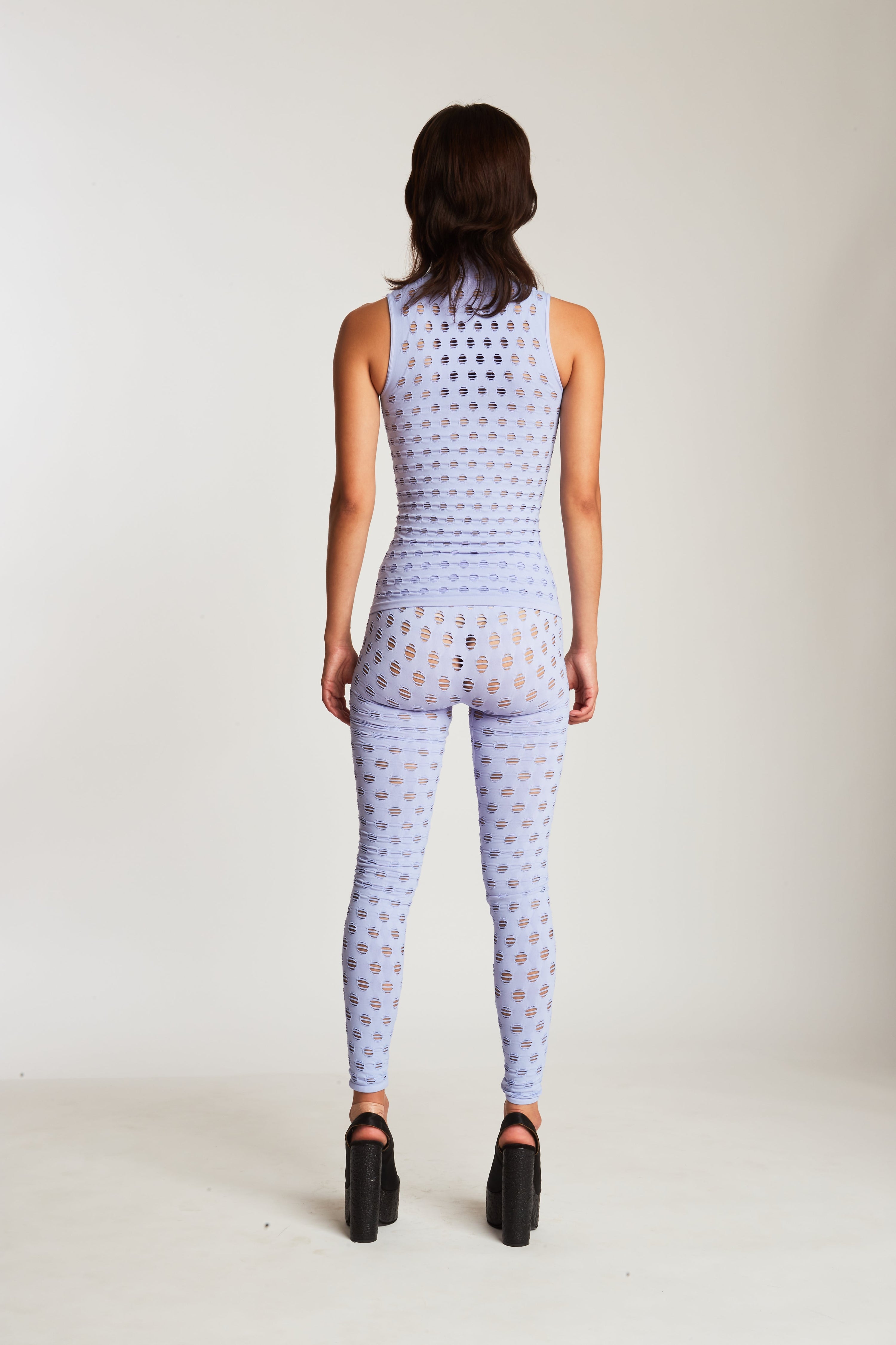 Perforated sleeveless turtleneck