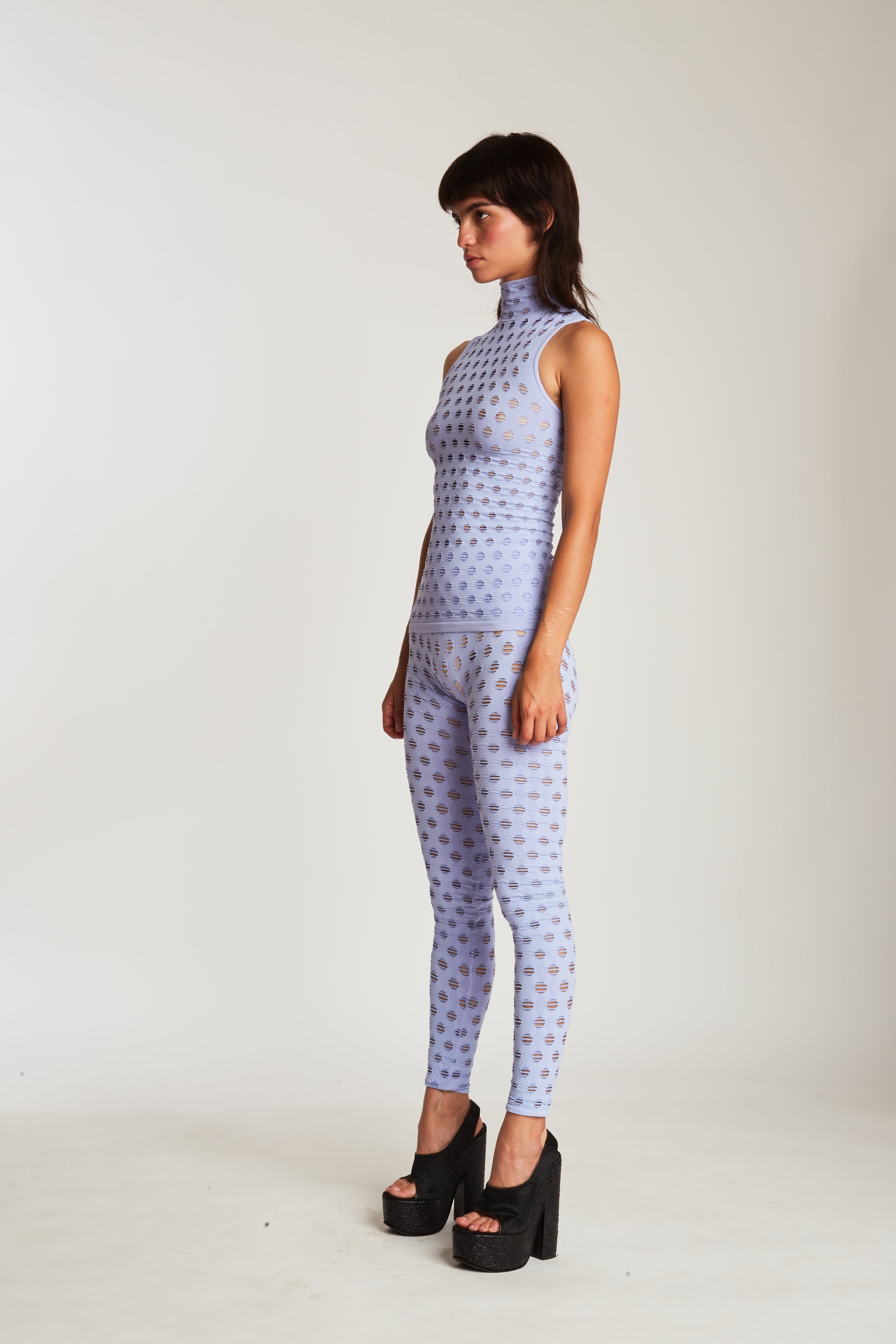 Perforated sleeveless turtleneck