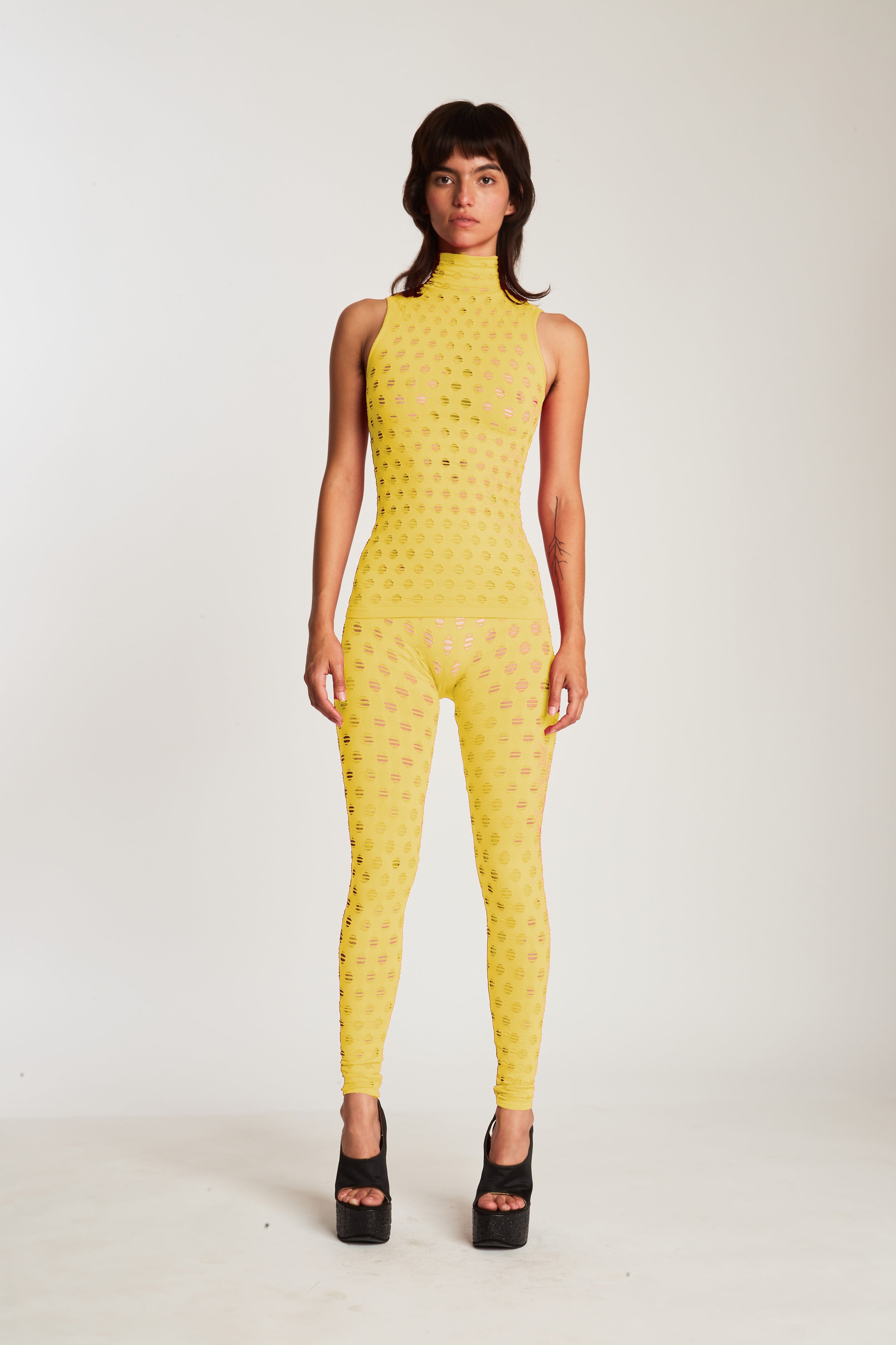 Perforated sleeveless turtleneck