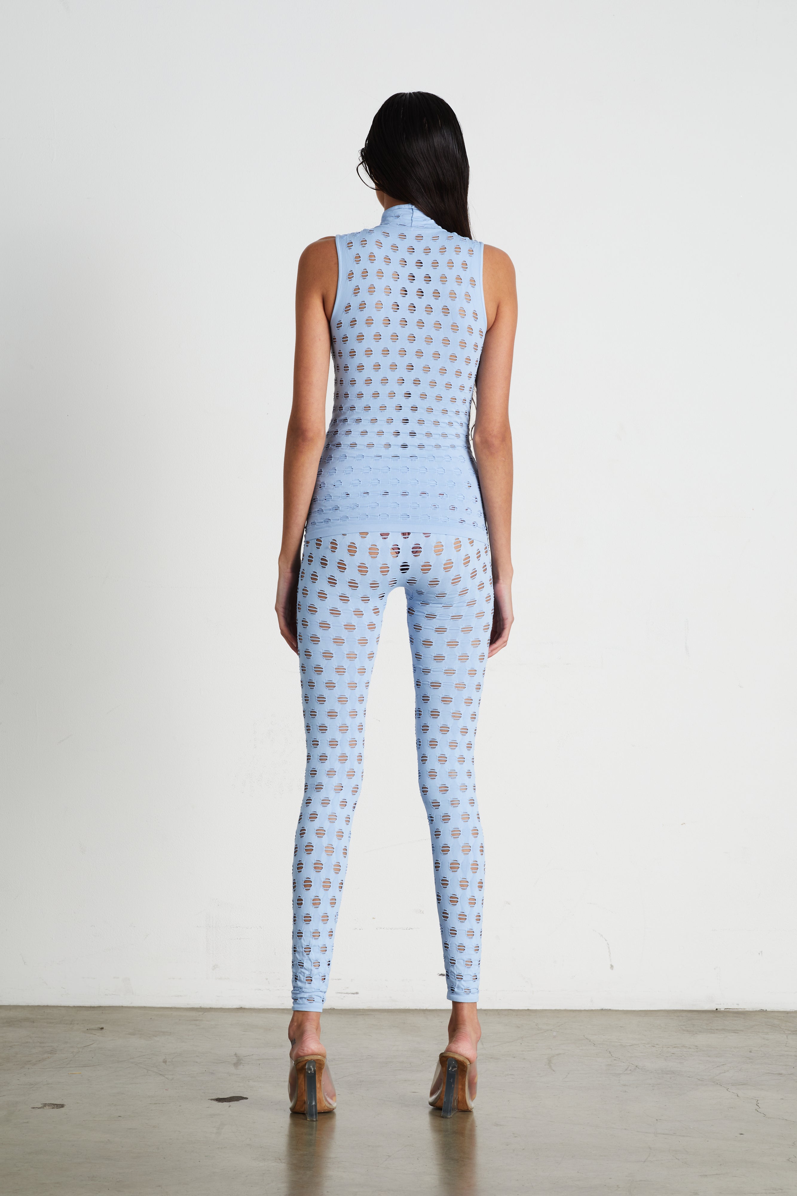 Perforated sleeveless turtleneck
