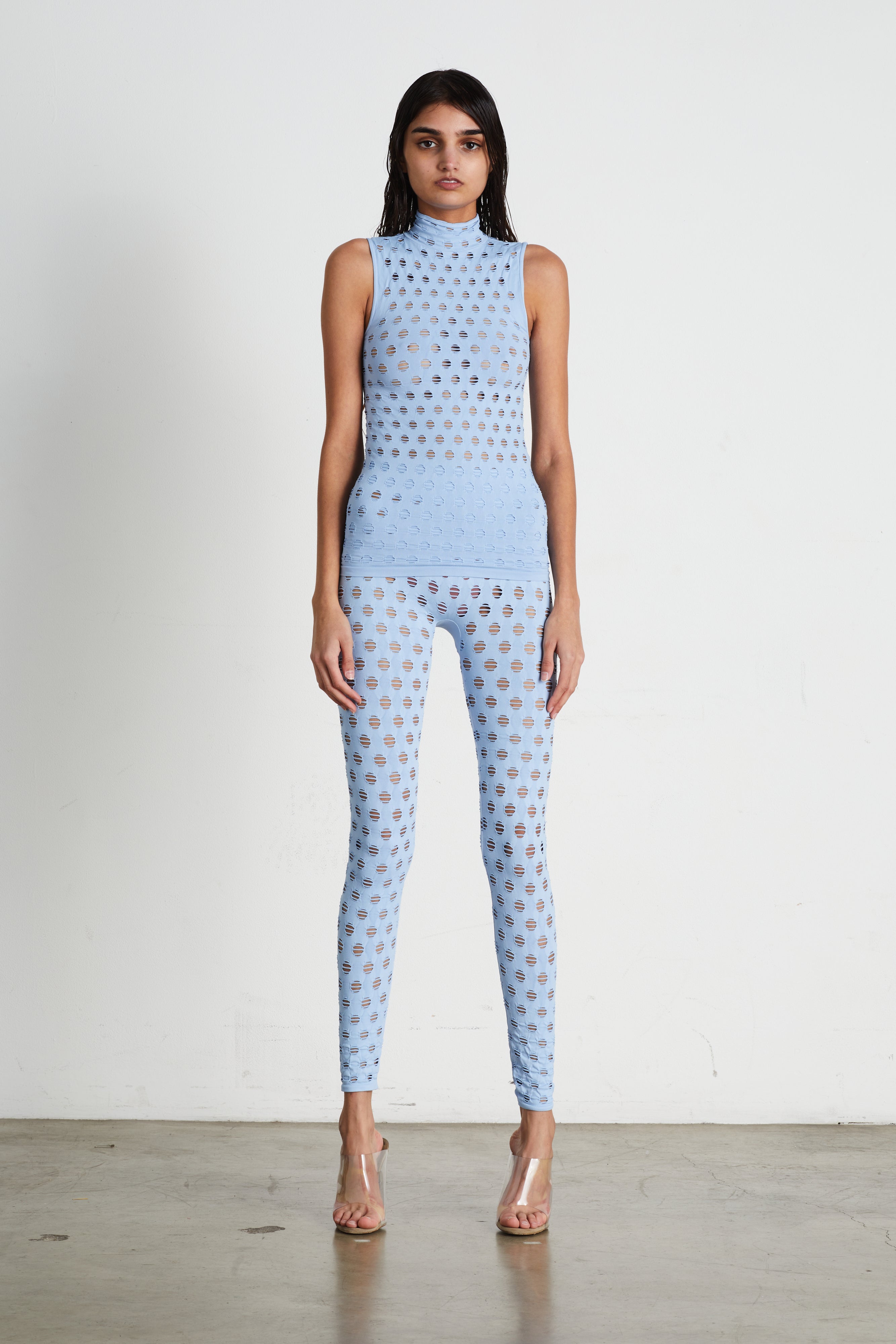 Perforated sleeveless turtleneck