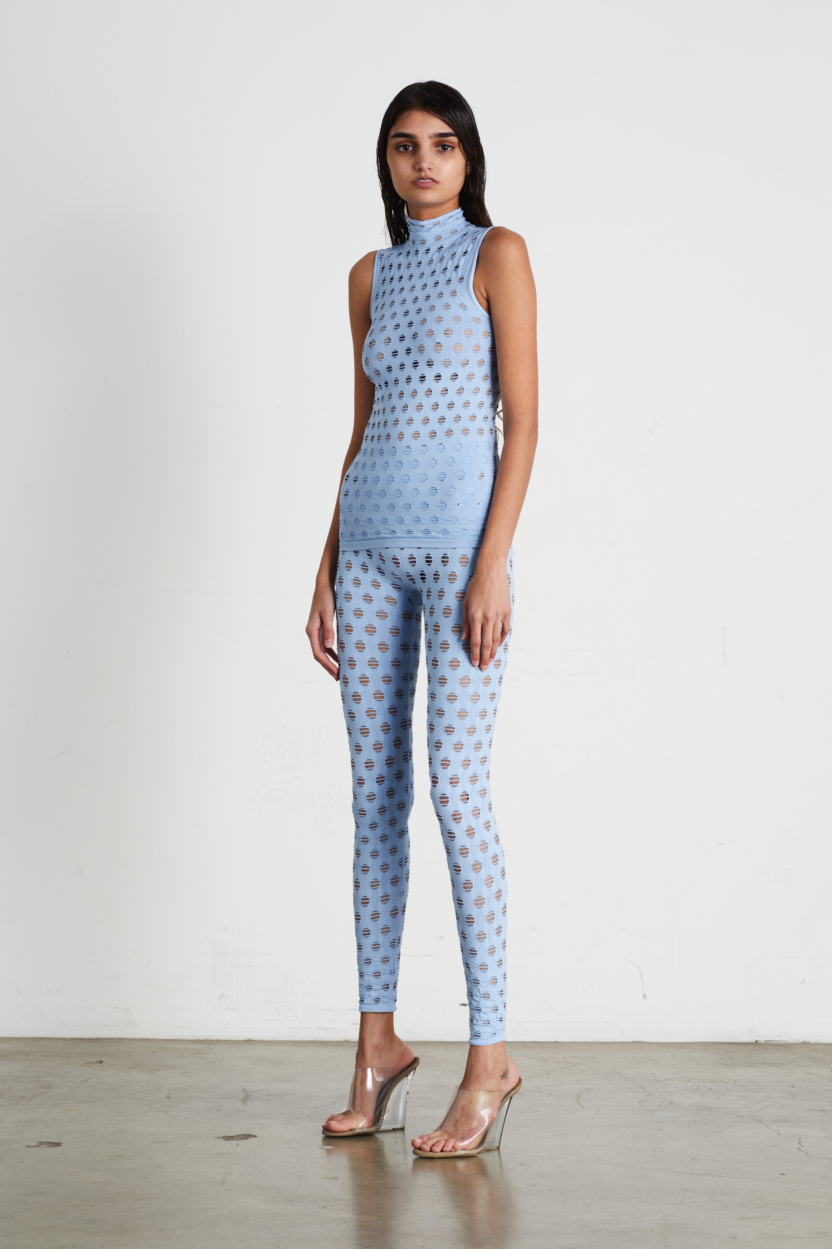 Perforated sleeveless turtleneck