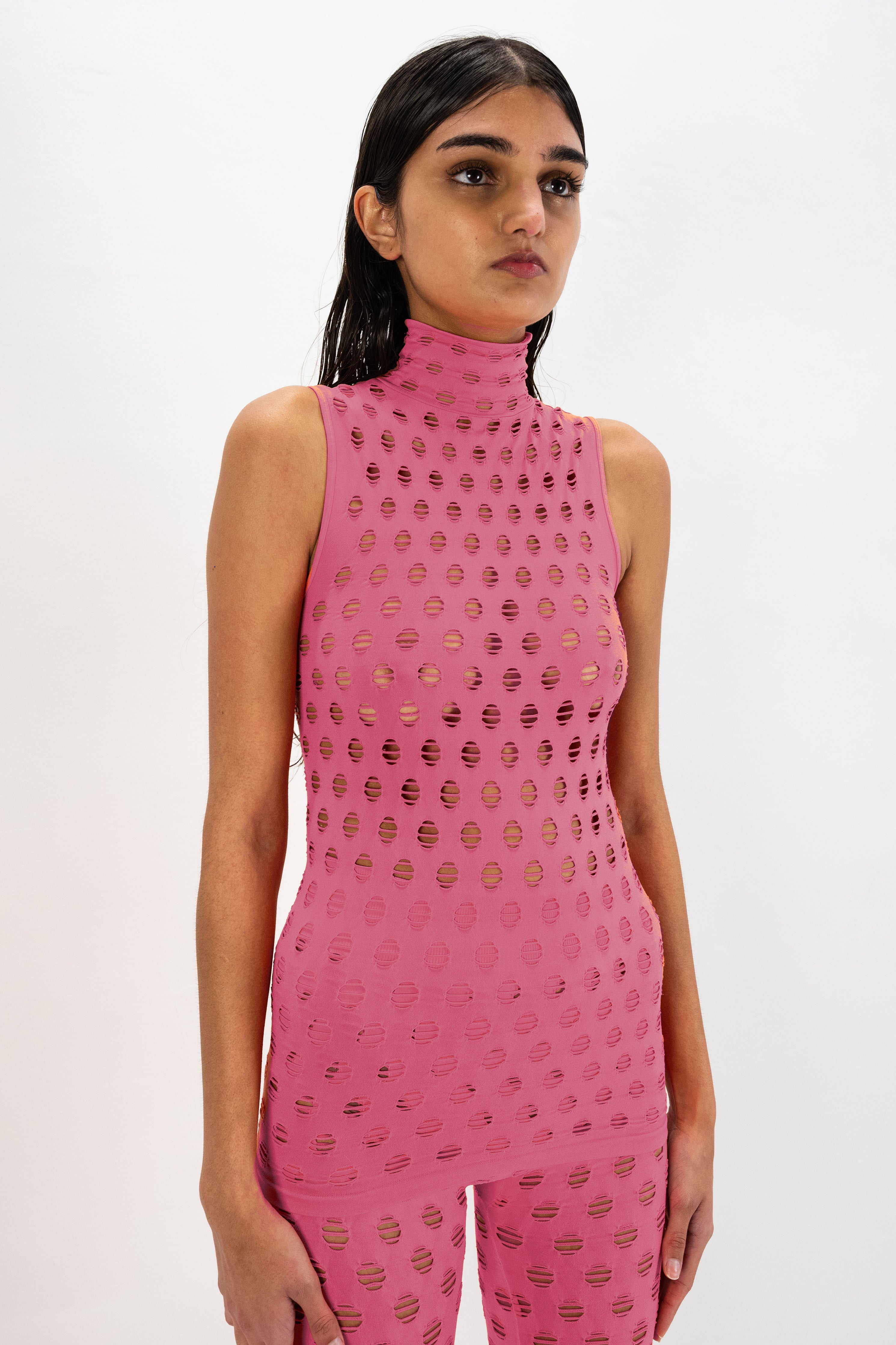 Perforated sleeveless turtleneck