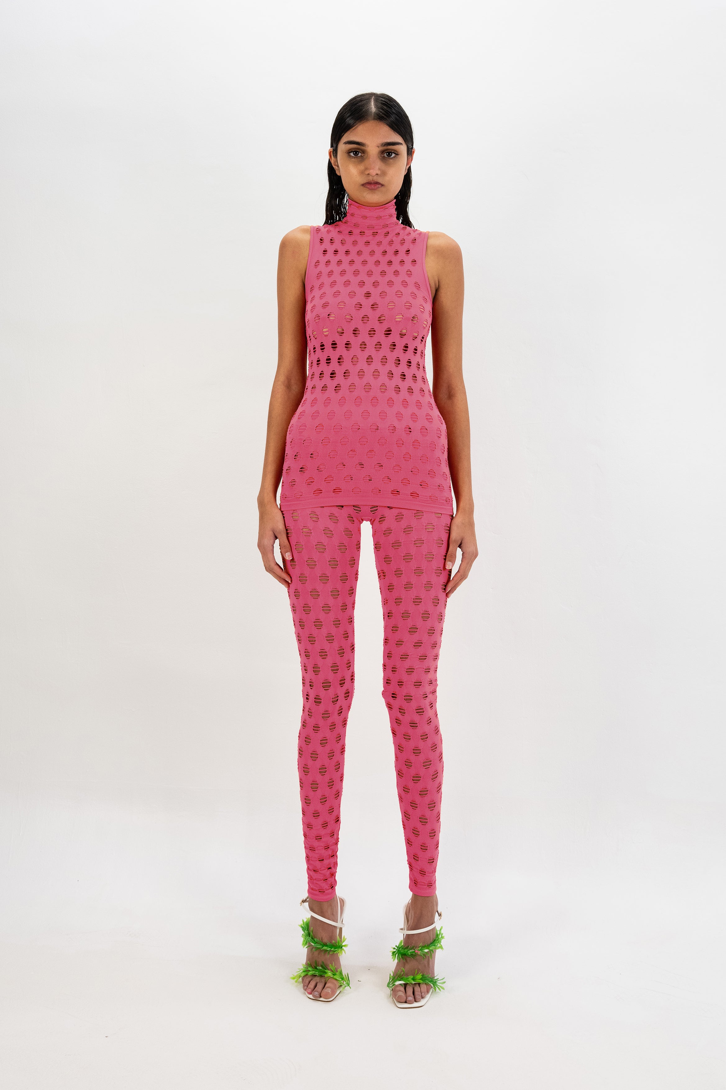 Perforated sleeveless turtleneck