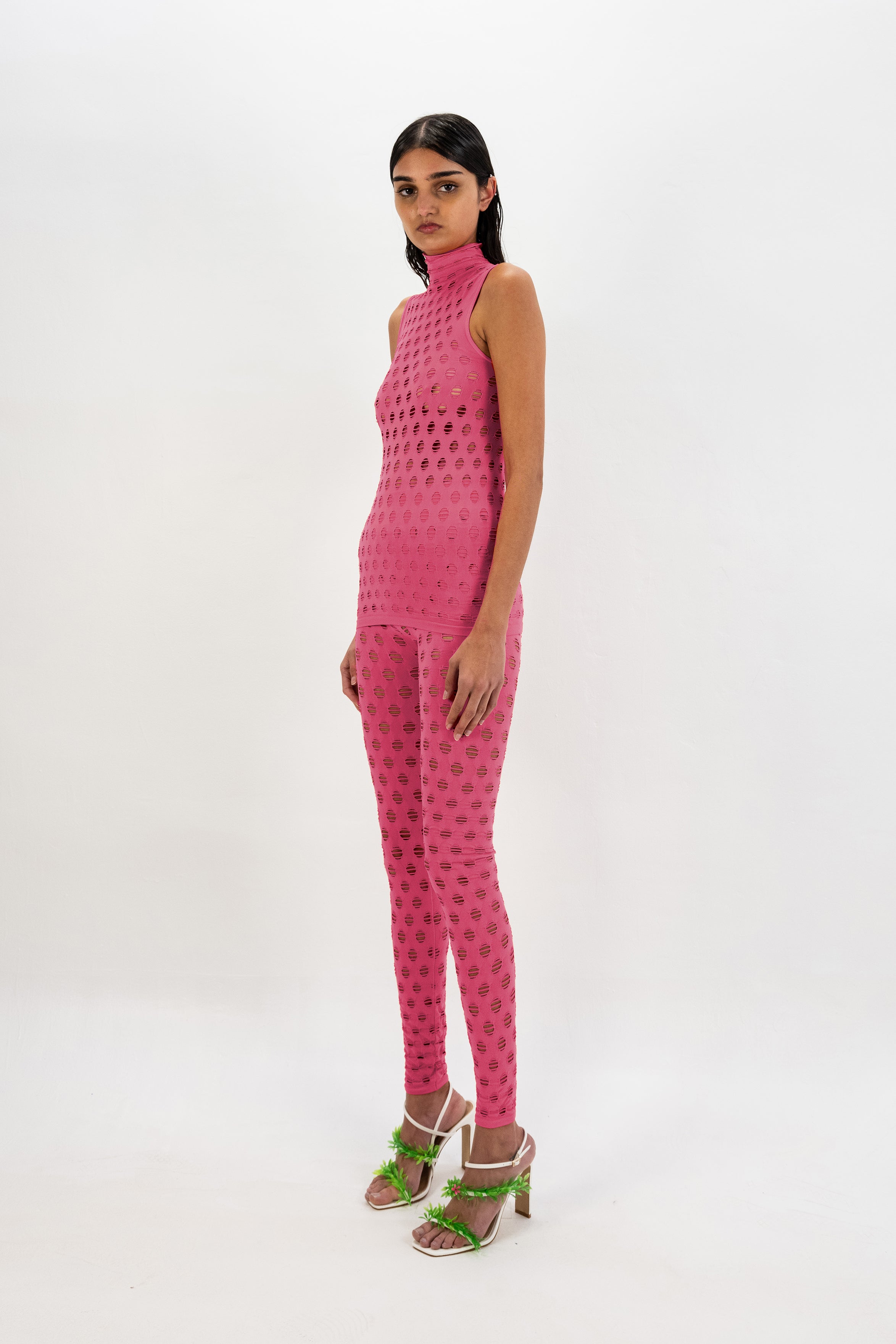 Perforated sleeveless turtleneck