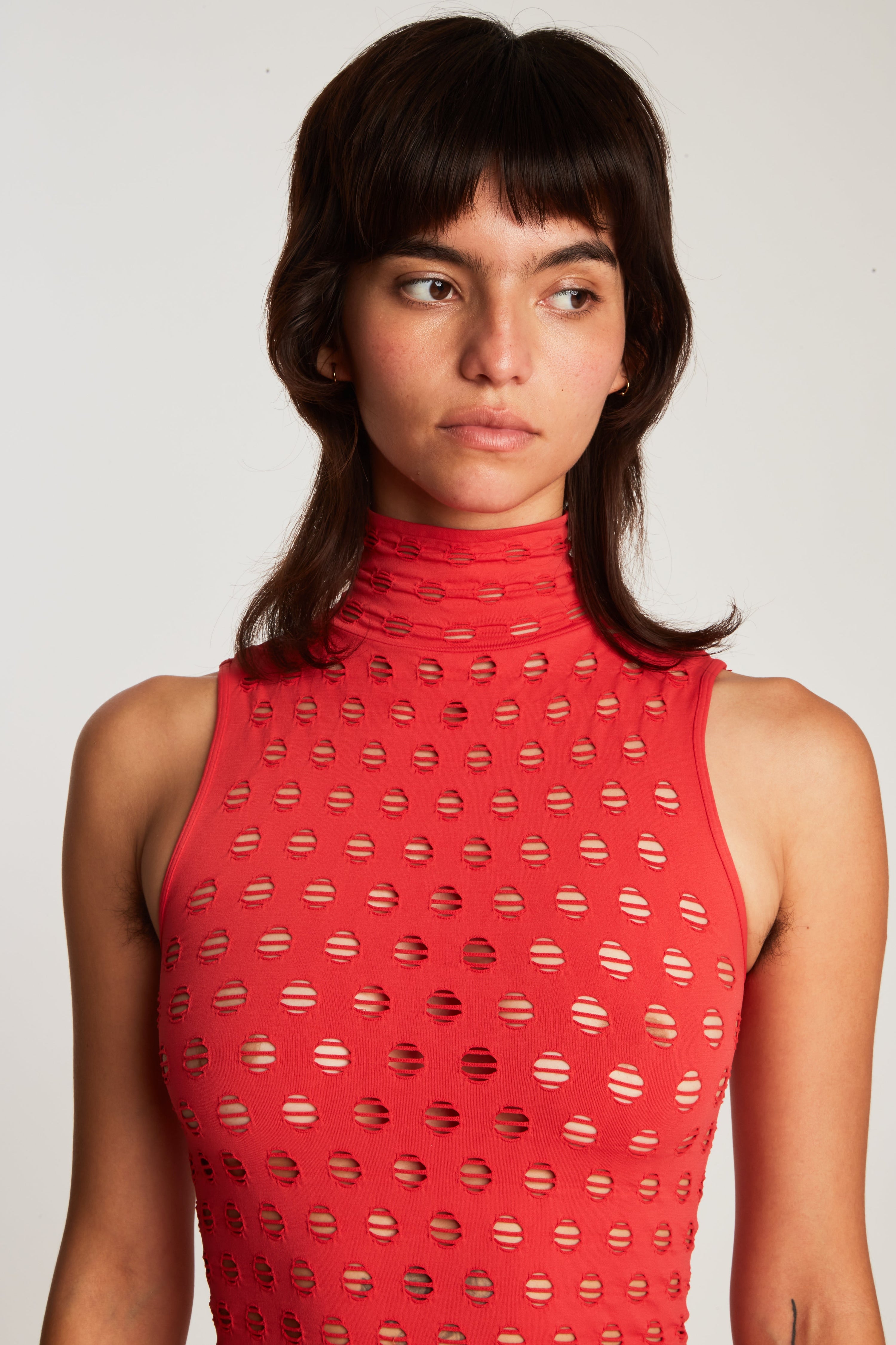 Perforated sleeveless turtleneck