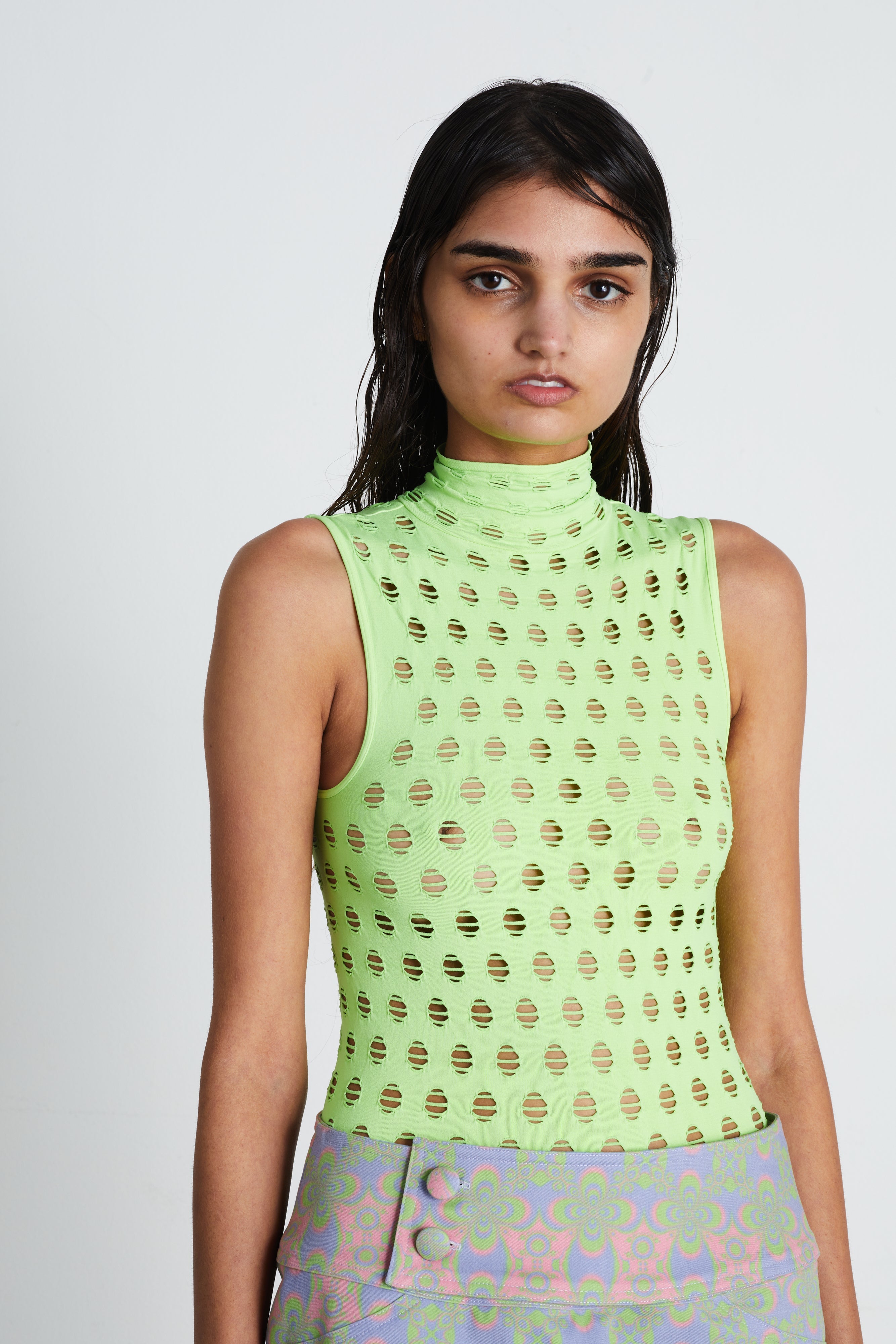Perforated sleeveless turtleneck