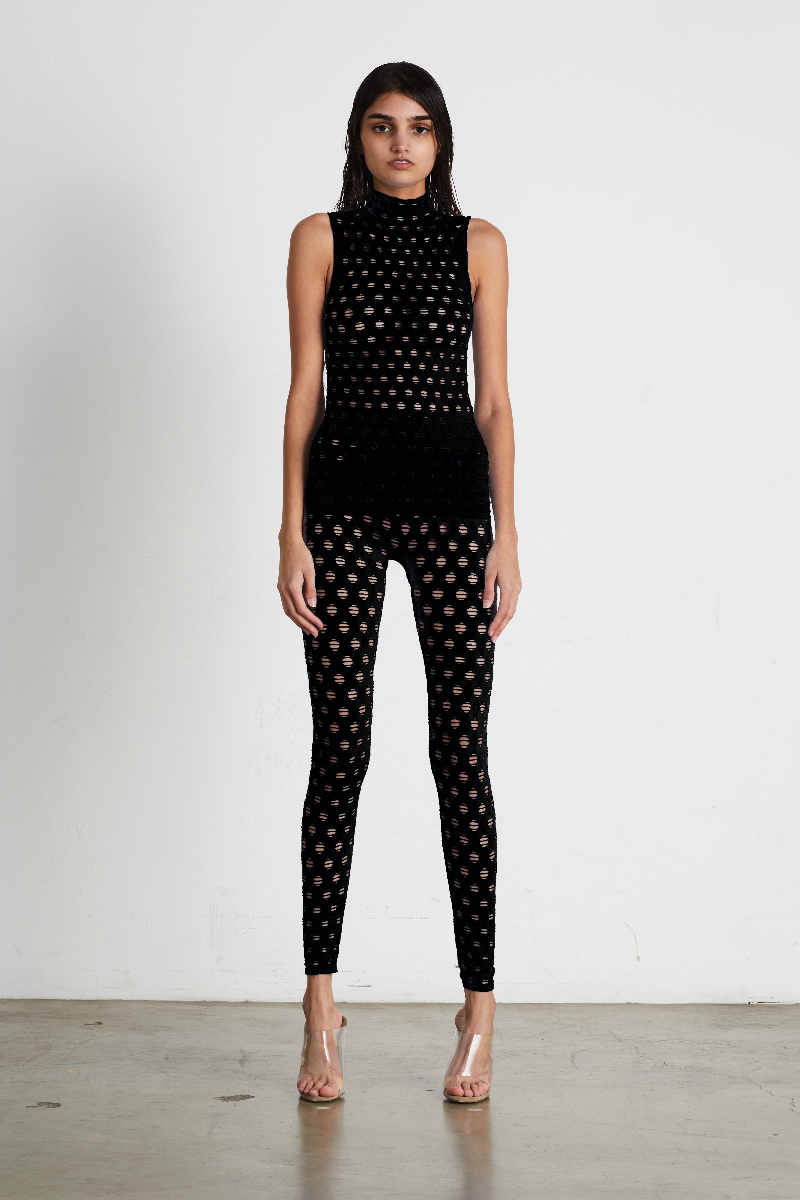 Perforated sleeveless turtleneck