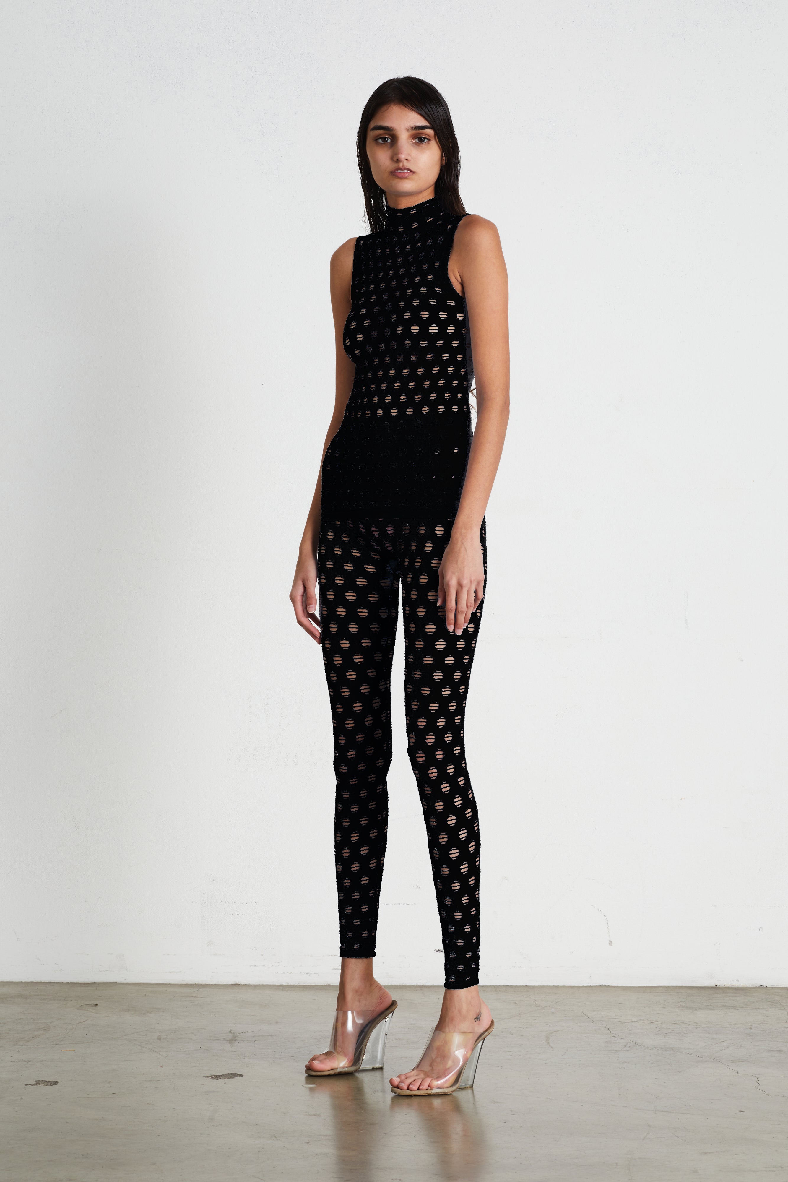 Perforated sleeveless turtleneck