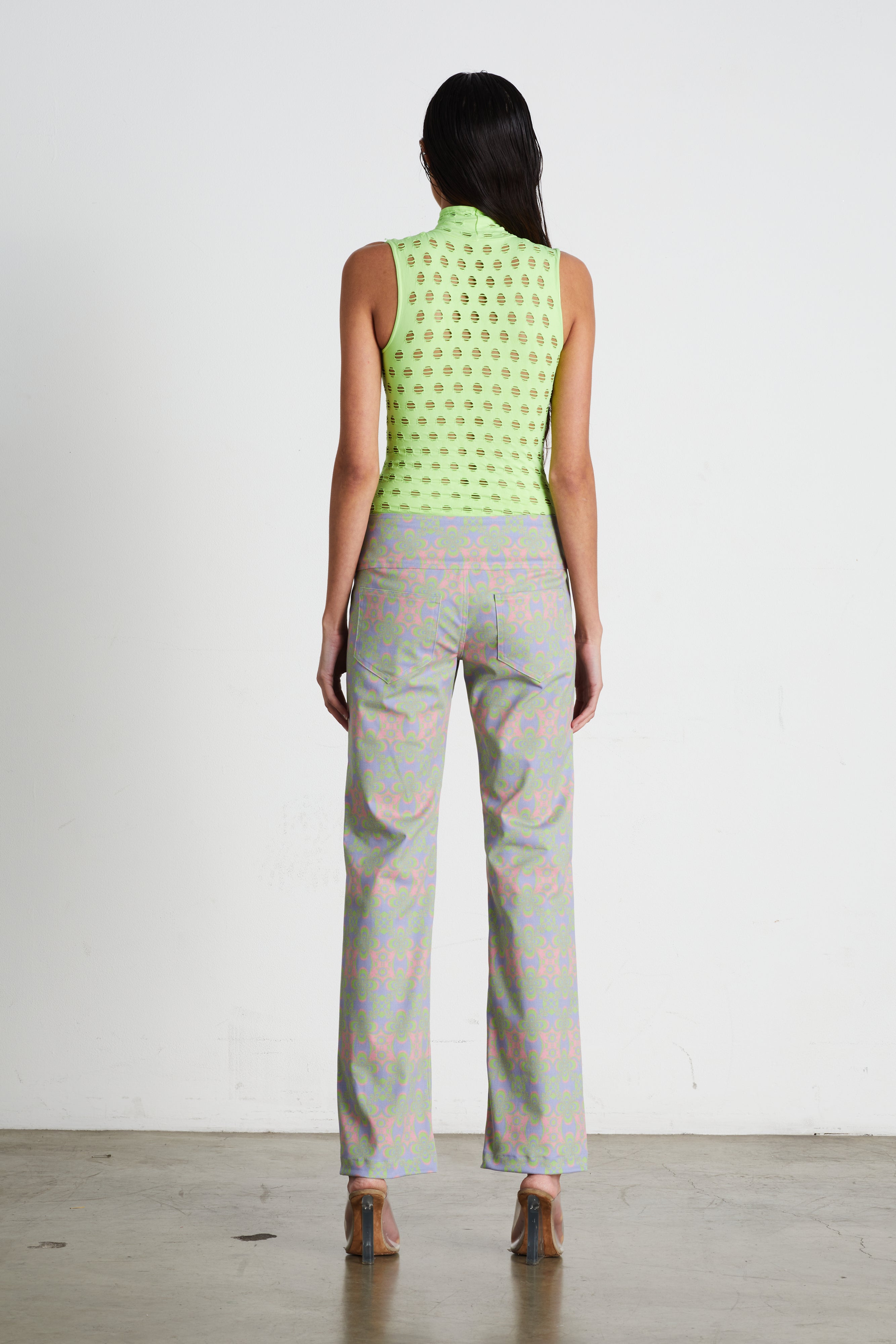 Perforated sleeveless turtleneck