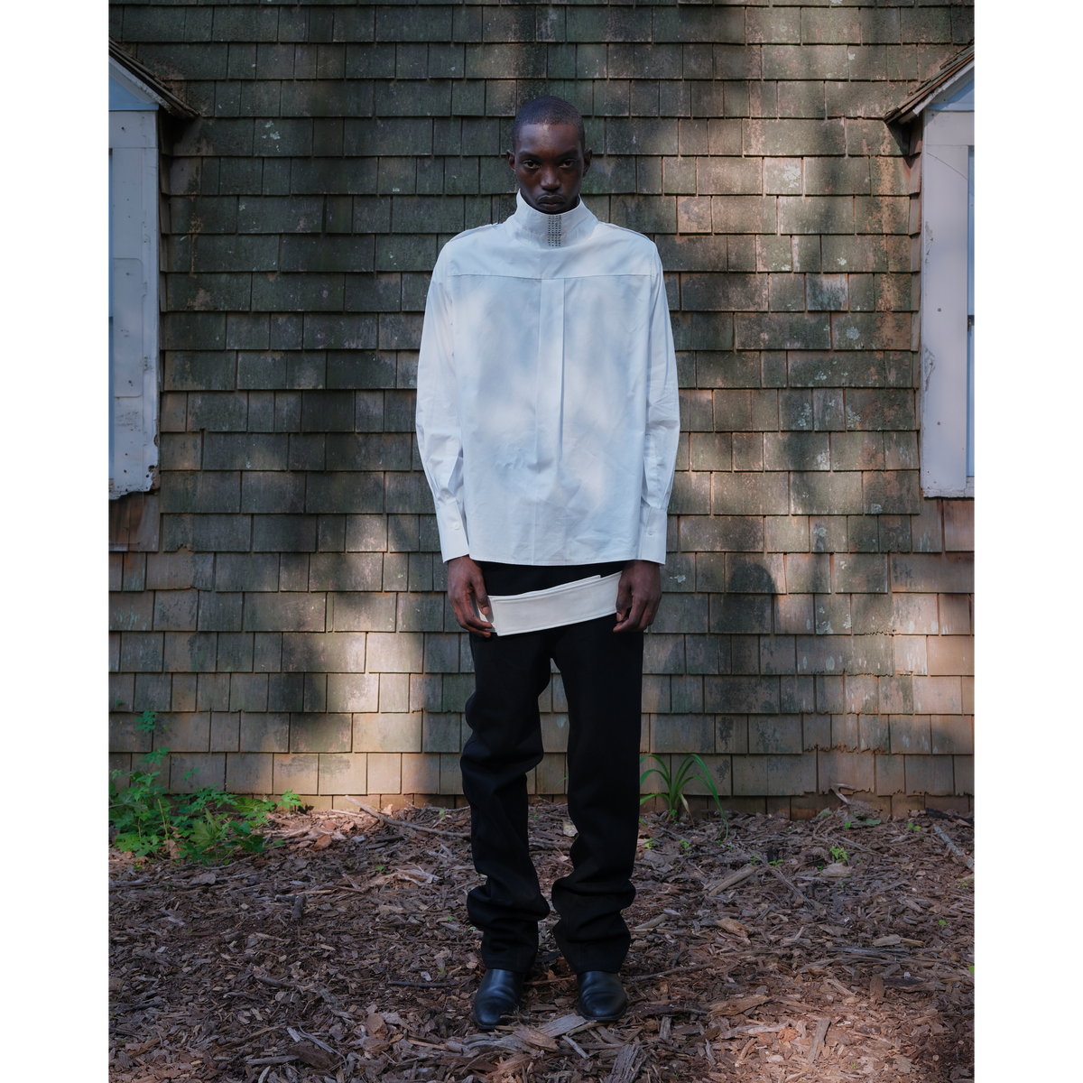 Belted leather-panel jeans