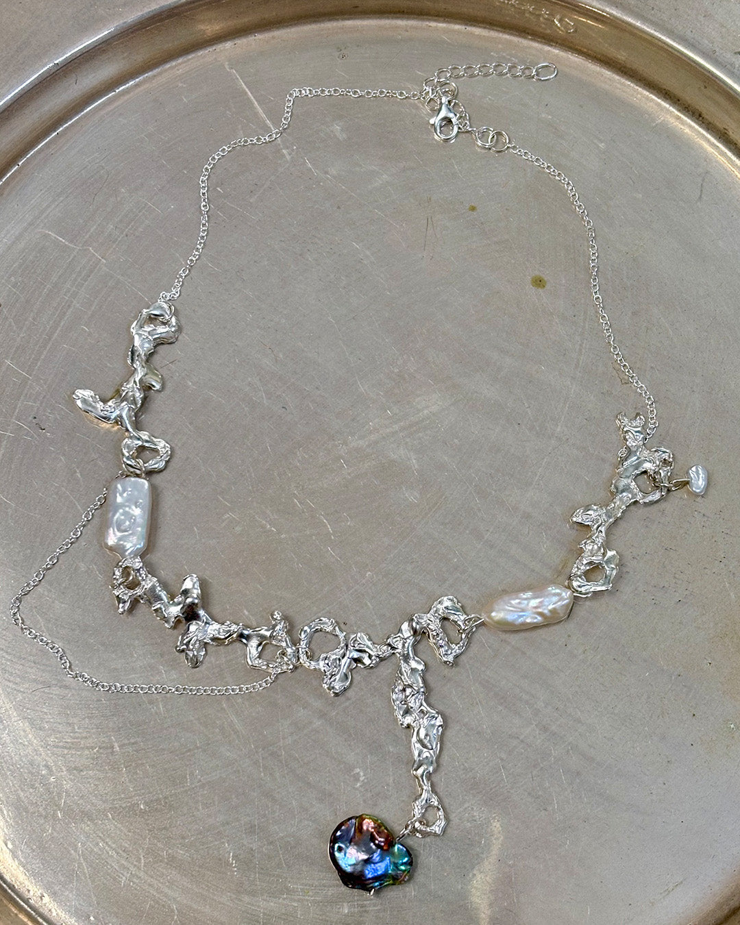 Fluid erosion necklace