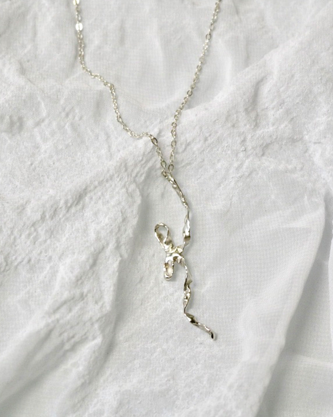 Burnt bow pendant - silver